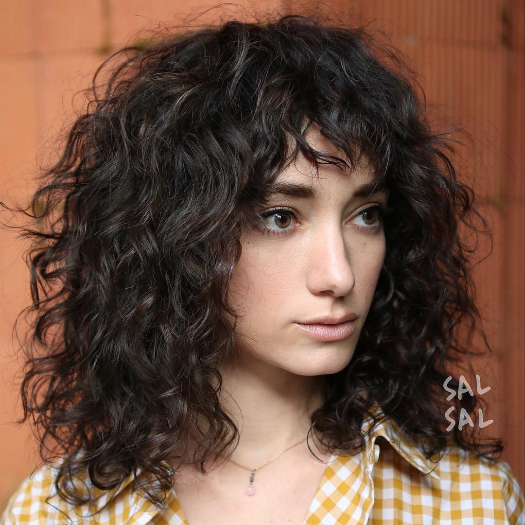 Mid-Length Curly Hair With A Fringe