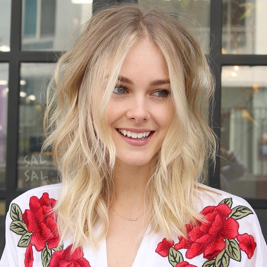 Medium Layered Blonde Hairstyle With Centre Parting